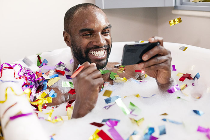 Man playing Buzz Bingo in the bath